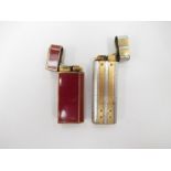 Two Cartier lighters in red enamel/gold plate, No.