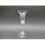 An early 18th Century wine glass with bell - shaped bowl set on a compressed three ring collar knop