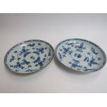 Two early 19th Century blue and white circular dishes with stylised floral design, 22cm diameter,