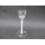 An 18th Century wine glass with ogee bowl engraved with rose bud and leaves,
