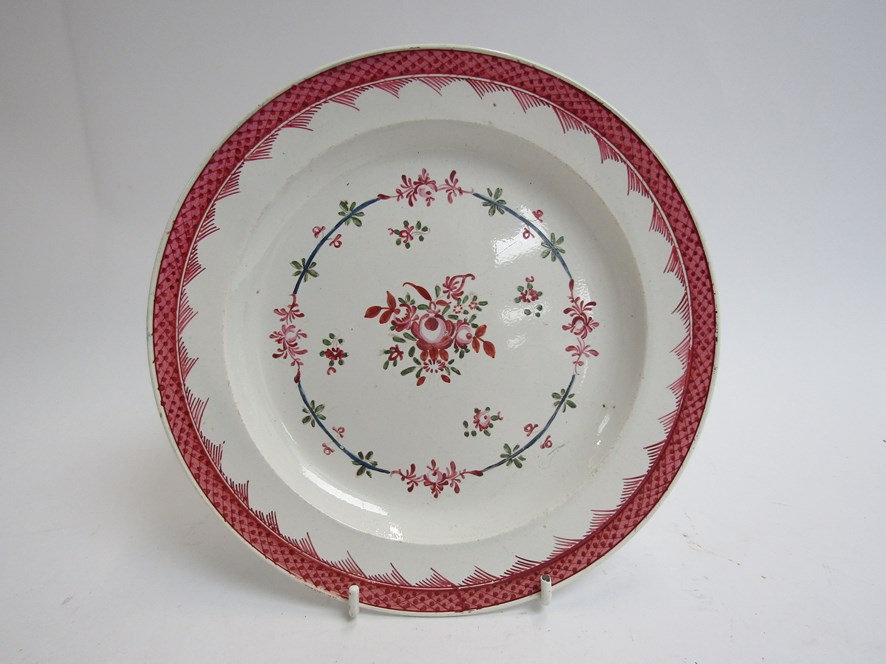 An 18th Century English plate with scale border, floral centre,