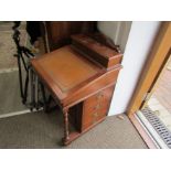 A Victorian mahogany Davenport desk, tooled tan leather slope, row of drawers, ring turned supports.