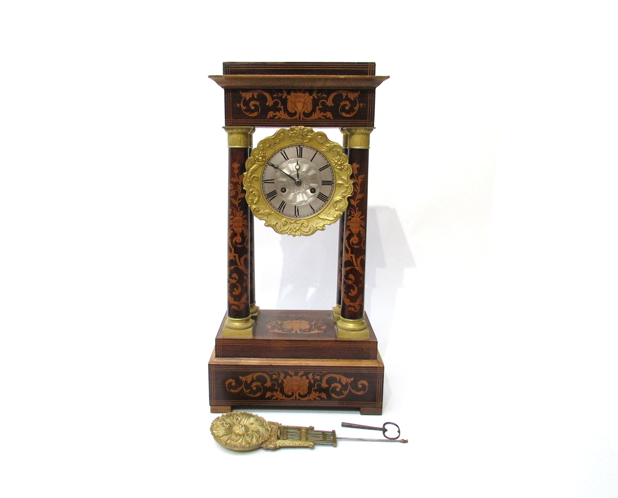 A 19th Century rosewood and satin inlaid French portico mantel clock,