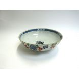 An 18th Century English delft bowl with handpainted floral sprays, hole to base, for restoration,