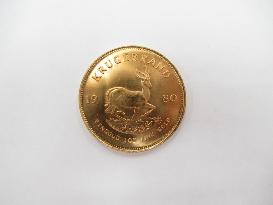 A 1980 South African Krugerrand with Chartered Bank plastic case