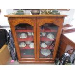 A Victorian burr walnut bookcase, two doors opening to reveal lined shelf space,