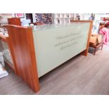 A modern bespoke walnut finish display/shop counter, shelved interior, script to glass front.