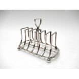 A James Deakin & Sons (John & William F Deakin) seven bar toast rack of outswept form, on ball feet,