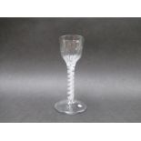 A mid 18th Century wine glass with panel - moulded ogee bowl raised upon a double white cotton