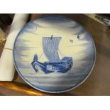 A Chinese plate with painted junk ship, hairline cracks,