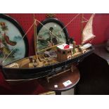 A model fishing boat on stand,