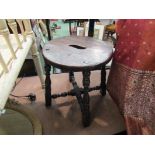 A pair of oak Victorian stools with fret handles to the round and oval seat on turned legs and