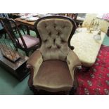 A circa 1860 mahogany button back rest armchair with scroll carved decoration on turned legs and