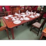 An Arts & Crafts oak extending dining table with two extra leaves and winding handle,