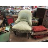 An early Victorian walnut armchair of small proportions on turned and tapering feet with brass cup