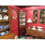 A 19th Century inlaid mahogany corner cabinet the astragal glazed single door cabinet over a single