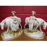 A pair of Staffordshire figural groups, boy and milkmaid with cows,