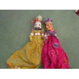 Two Indian wooden hand painted dolls wearing colourful Indian fabric robes