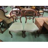 A pair of mid Victorian carved walnut chairs on cabriole fore legs