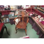 An elm and oak Windsor armchair the dished seat on cabriole legs and crinoline stretcher