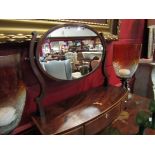 A George III mahogany bow front toilet mirror with three base drawers and key,