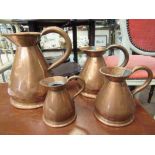 Four 19th Century graduating copper flagons quart/pint/half pint/gill