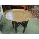 A brass top tray table with metamorphic base,