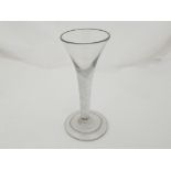 An early 18th Century drinking glass, circa 1750 with a trumpet shaped bowl above air twist stem,