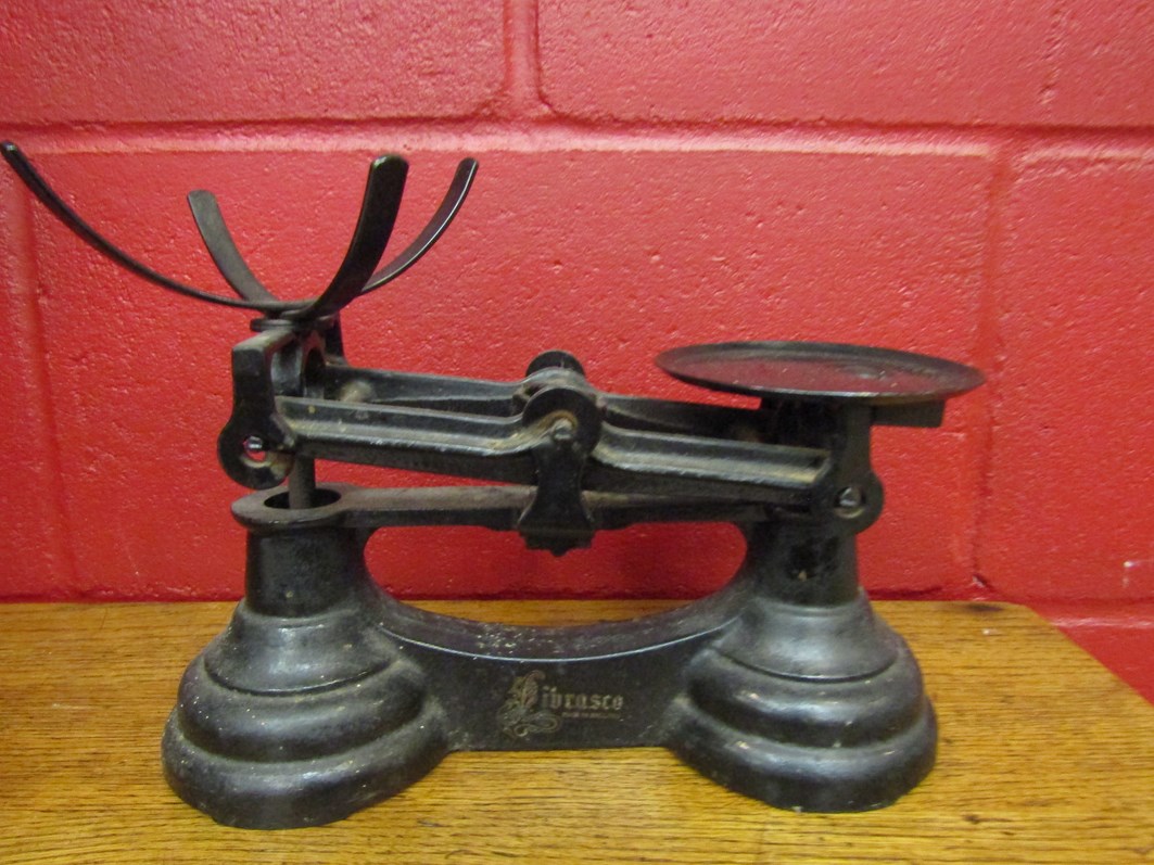 A set of bygone scales with various brass weights