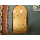 A bygone vintage bagatelle board with original balls