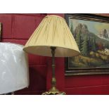 A brass three footed table lamp with pleated shade,