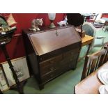 A George III oak bureau the fitted interior with document well over two short and two long drawers