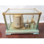 A barograph in gilt brass casing (tarnished) marked L & M. made in frame, no.