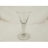 An 18th Century drinking glass, circa 1740 with a trumpet shaped bowl above plain stem,