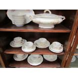 A quantity of Limoges dinner wares including plates, cups and saucers, tureens etc.