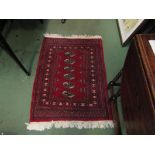 A Pakistani Bokhara red ground rug with multiple borders,