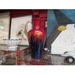 A German art glass jug in blue and red, clear handle,