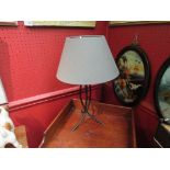 A black metal lamp base with grey shade,