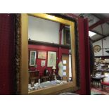 A gilt antique frame, oak leaf design, adapted into a wall mirror,