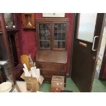 An oak three drawer bureau bookcase with lead glazed doors,
