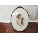 A photograph of young girl holding a teddy in oval metal frame marked Moseley Ware,