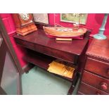 A circa 1840 flame mahogany two tier side table the raised back over two frieze drawers and under
