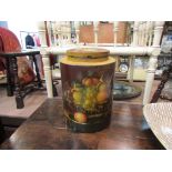 A papier-mâché lidded container painted with fruit,