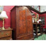 A walnut two door fitted wardrobe above single drawer on cabriole leg base,