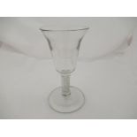 An 18th Century drinking glass circa 1760 with a bell shaped bowl above treble series opaque twist