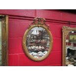 A 19th Century style gilt wall mirror, oval form with ribbon crest,