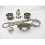 A small quantity of silver items consisting of three napkin rings, a heart shaped pill box,