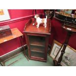 A mahogany single glazed door cabinet with shelved interior,