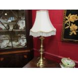 A pair of brass table lamps with shades