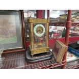 An ornate mantel clock in square frame with numbered dial and mechanism